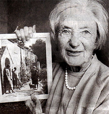 Helen Taylor with a photo of her old home at Tyneham. Photo: Copyright and used with permission of Phil Yeomans BNPS Agency.