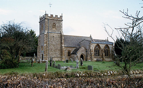 The Parish Church of St Mary stands in a spacious tidy churchyard surrounded by a stone wall.