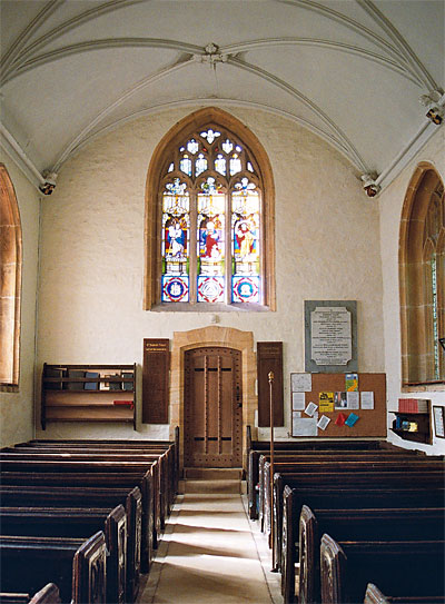 The Nave looking west towards 15th century window and door, which leads to modern vestry.