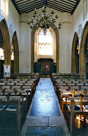 A view inside St. Mary's Church from the chancel screen down the nave, through the tower arch to the main entrance.