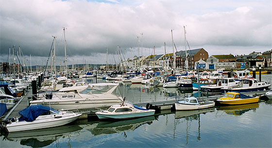 A view of The Marina in the upper reaches of the harbour as it tucks in around Melcombe Regis. It is home to some of the smaller craft moored at Weymouth.