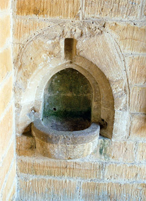 As you enter the church on your right is a stoup, the recessed bowl would have contained holy (blessed) water.