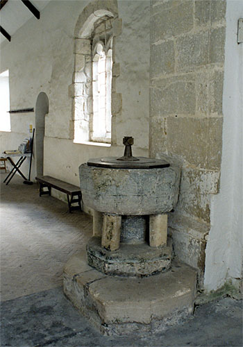 The early 13th century font is of Purbeck marble.